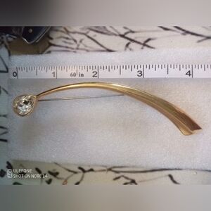 Sleek Gold Brooch with Crystal Detail